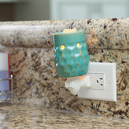 Turquoise pluggable fragrance warmer in plug